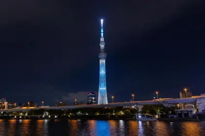 a tall tower lit up in blue at night at Skytree View Terrace in Tokyo