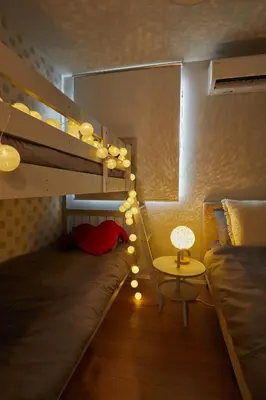 a small room with a bunk bed and a table at Skytree View Terrace in Tokyo