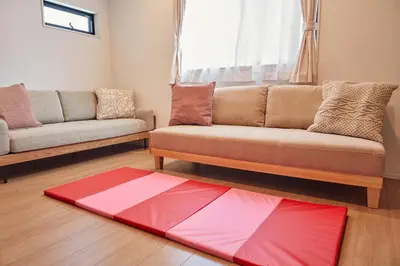 a living room with a couch and a red rug at Skytree View Terrace in Tokyo