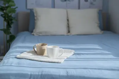 two coffee cups sitting on a towel on a bed at Skytree View Terrace in Tokyo