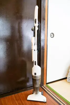 a robot standing on the floor next to a door at Near Shinjyuku hostel in Tokyo