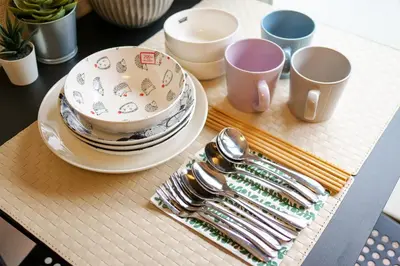 a table with plates and utensils on a tray at Near Shinjyuku hostel in Tokyo
