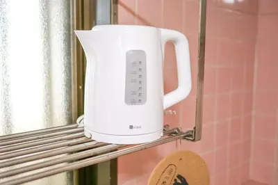 a white appliance is sitting on a shelf at Near Shinjyuku hostel in Tokyo