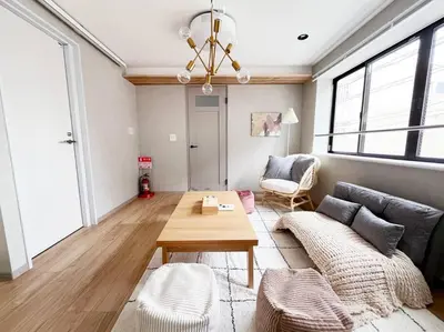 a living room with a couch and a table at tnw\u5357\u9577\u5d0e3\u4e01\u76ee in Tokyo