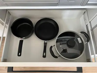 two frying pans and a mirror on a wall at tnw\u5357\u9577\u5d0e3\u4e01\u76ee in Tokyo