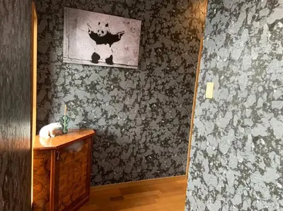 a bathroom with a sink and a wall with a picture at \u67f4\u53c81\u4e01\u76ee in Tokyo