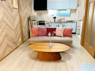 a living room with a couch and a wooden table at \u67f4\u53c81\u4e01\u76ee in Tokyo