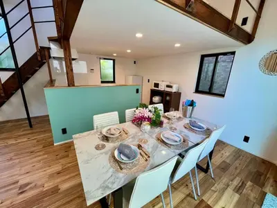 a dining room with a table and white chairs at House22 -Brand new house in Tokyo