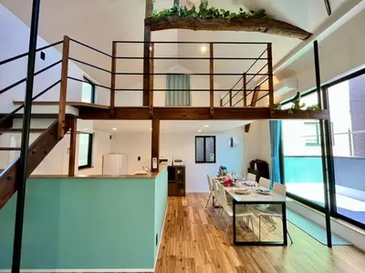 a living room with a staircase and a dining table at House22 -Brand new house in Tokyo