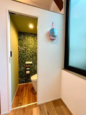a bathroom with a toilet and a television on a wall at House22 -Brand new house in Tokyo