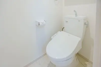 a bathroom with a white toilet with a roll of toilet paper at QH101, Newly renovated hotel, direct access to Ueno, Asakusa, Disneyland, Airport, in Tokyo