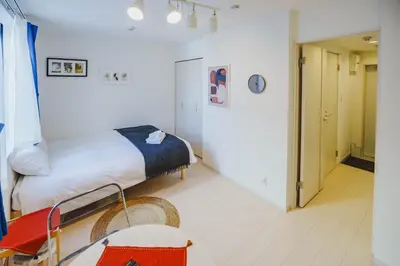 a small room with a bed and a hallway at QH101, Newly renovated hotel, direct access to Ueno, Asakusa, Disneyland, Airport, in Tokyo