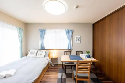 a small bedroom with a bed and a table at YJ-HOTEL kamiikebukuro 3F \u5317\u6c60\u888b5\u5206\u949f \u65b0\u88c5\u4e0a\u7ebf 61\u5e73\u65b9 in Tokyo