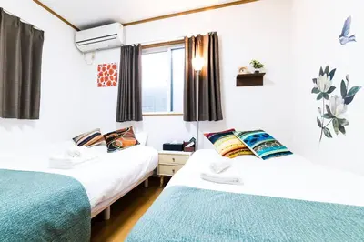 a room with two beds and a window at \u672c\u753a2\u4e01\u76ee in Tokyo