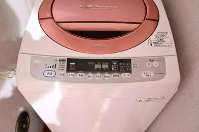 a washing machine with a control panel on top of it at \u672c\u753a2\u4e01\u76ee in Tokyo