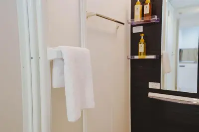 a bathroom with a towel rack and a mirror at QH102, Newly renovated hotel, direct access to Ueno, Asakusa, Disneyland, Airport in Tokyo