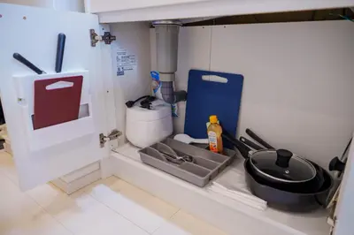 a kitchen with a sink and a utensil at QH102, Newly renovated hotel, direct access to Ueno, Asakusa, Disneyland, Airport in Tokyo
