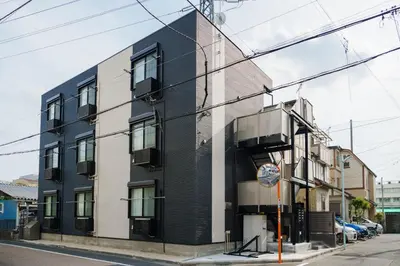 a black and white building on a city street at QH102, Newly renovated hotel, direct access to Ueno, Asakusa, Disneyland, Airport in Tokyo
