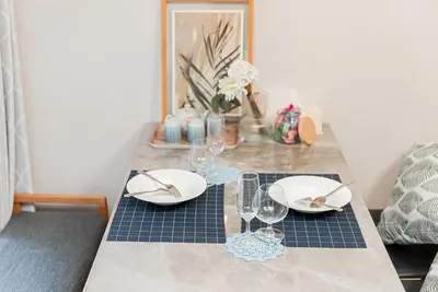 a table with plates and wine glasses on it at YJ-HOTEL kamiikebukuro 1F \u5317\u6c60\u888b5\u5206\u949f \u65b0\u88c5\u4e0a\u7ebf 52\u5e73\u65b9 in Tokyo