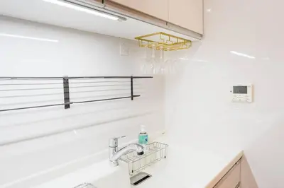 a white bathroom with a sink and a mirror at Kita-Akabane - Diamond Yu in Tokyo