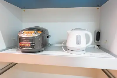 a slow cooker and a toaster sitting on a shelf at Kita-Akabane - Diamond Yu in Tokyo
