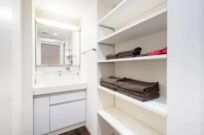 a white bathroom with a sink and a mirror at Kita-Akabane - Diamond Yu in Tokyo