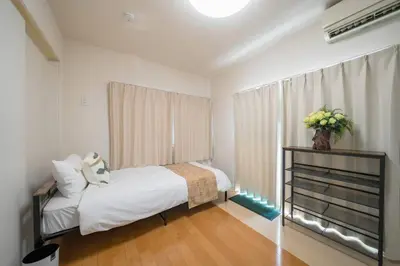 a small bedroom with a bed and a window at Kita-Akabane - Diamond Yu in Tokyo