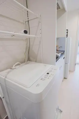 a white refrigerator freezer sitting inside of a kitchen at QH103, Newly renovated hotel, direct access to Ueno, Asakusa, Disneyland, Airport in Tokyo