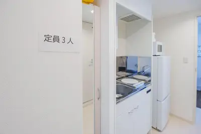 a kitchen with a sink and a refrigerator at QH201, Newly renovated hotel, direct access to Ueno, Asakusa, Disneyland, Airport in Tokyo