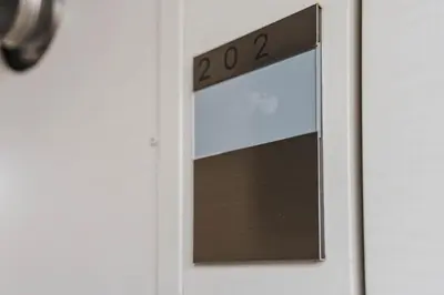 a door with a clock on top of it at QH202, Newly renovated hotel, direct access to Ueno, Asakusa, Disneyland, Airport in Tokyo