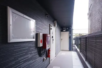 a hallway with a window on a black brick wall at QH202, Newly renovated hotel, direct access to Ueno, Asakusa, Disneyland, Airport in Tokyo