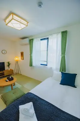 a bedroom with a large white bed and a window at QH301, Newly renovated hotel, direct access to Ueno, Asakusa, Disneyland, Airport in Tokyo