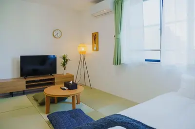 a living room with a television and a table at QH301, Newly renovated hotel, direct access to Ueno, Asakusa, Disneyland, Airport in Tokyo