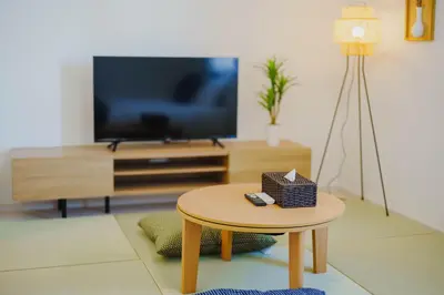a living room with a table and a tv at QH301, Newly renovated hotel, direct access to Ueno, Asakusa, Disneyland, Airport in Tokyo