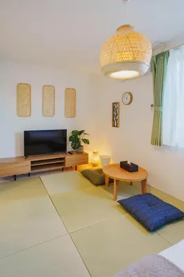a living room with a television and a table at QH302, Newly renovated hotel, direct access to Ueno, Asakusa, Disneyland, Airport in Tokyo