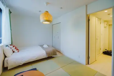 a bedroom with a bed in a room at QH302, Newly renovated hotel, direct access to Ueno, Asakusa, Disneyland, Airport in Tokyo
