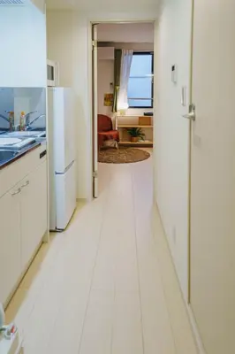 a kitchen with white floors and a white refrigerator at QH303, Newly renovated hotel, direct access to Ueno, Asakusa, Disneyland, Airport in Tokyo