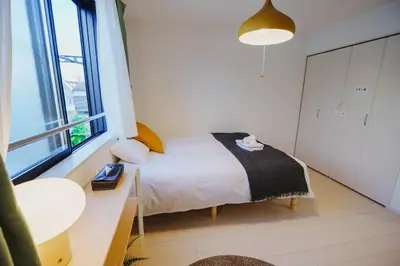a small bedroom with a bed and a window at QH303, Newly renovated hotel, direct access to Ueno, Asakusa, Disneyland, Airport in Tokyo