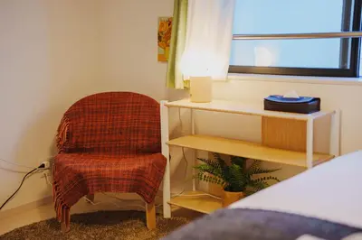 a bedroom with a chair and a desk and a window at QH303, Newly renovated hotel, direct access to Ueno, Asakusa, Disneyland, Airport in Tokyo