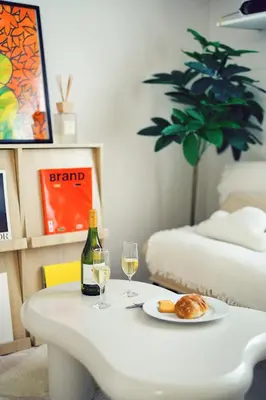 a table with two glasses of wine and a plate of food at Home Story in Tokyo Kanametyo-Ikebukuro-Ginzaまで直通&東京屋語 in Tokyo