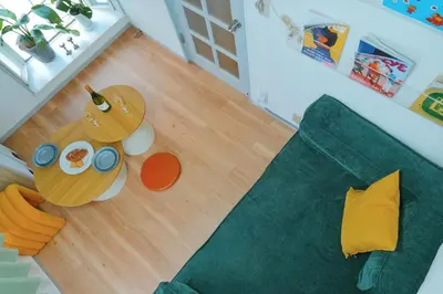 a living room with a green couch and a table at Home Story in Tokyo Kanametyo-Ikebukuro-Ginzaまで直通&東京屋語 in Tokyo