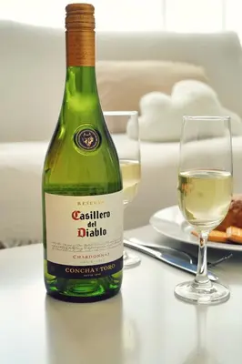 a bottle of white wine sitting next to a glass at Home Story in Tokyo Kanametyo-Ikebukuro-Ginzaまで直通&東京屋語 in Tokyo