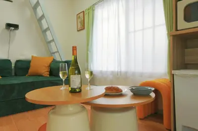 a living room with a table with two glasses of wine at Home Story in Tokyo Kanametyo-Ikebukuro-Ginzaまで直通&東京屋語 in Tokyo