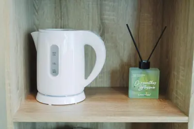 a coffee maker and a candle on a shelf at Home Story in Tokyo Kanametyo-Ikebukuro-Ginzaまで直通&東京屋語 in Tokyo