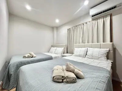 two beds in a bedroom with towels on them at Kenki Torigoe House-TT0173 in Tokyo