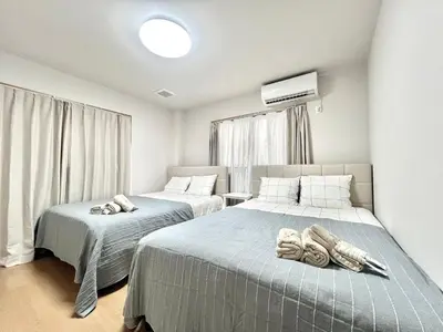 a bedroom with two beds with towels on them at Kenki Torigoe House-TT0173 in Tokyo