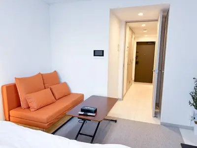 a living room with a couch and a table at Triphome Higahsi Shinjuku Brand New in Tokyo