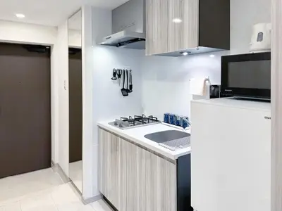 a small kitchen with a sink and a refrigerator at Triphome Higahsi Shinjuku Brand New in Tokyo