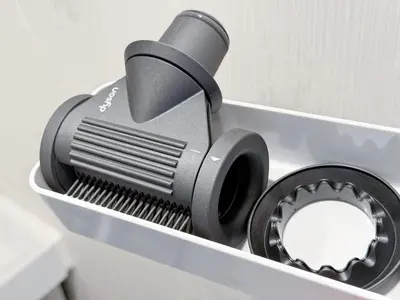 a black brush sitting on top of a toilet at Triphome Higahsi Shinjuku Brand New in Tokyo