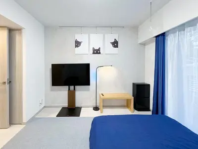 a bedroom with a bed and a flat screen tv at Triphome Higahsi Shinjuku Brand New in Tokyo